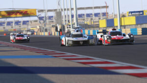 Le Mans Ultimate Screenshot of a Toyota Hypercar and a Peugeot Hypercar battling on Bahrain
